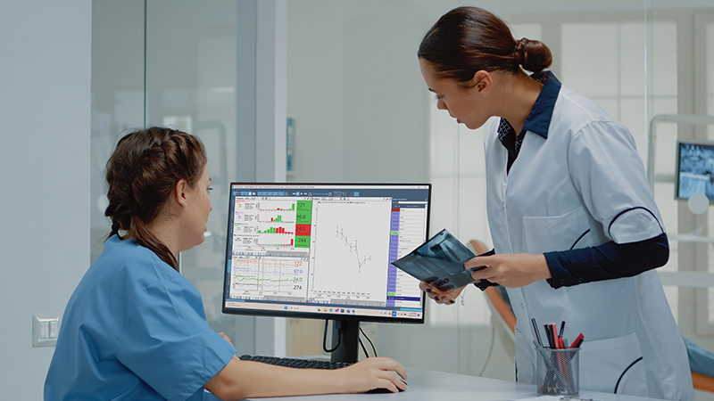 Medical professionals looking at Moberg CNS Envision software
